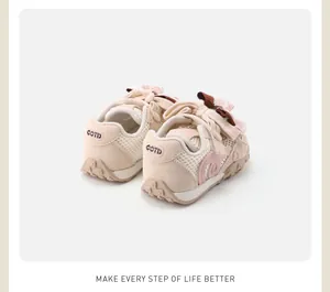 Detailed view of cream and pink toddler girls mesh sneakers with cute bow accents