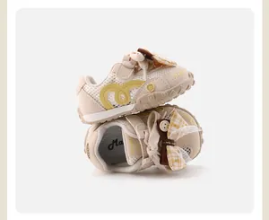Detail of breathable mesh baby sneakers with decorative bow and non-slip sole.