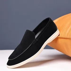 Detailed side view of men's black suede loafers with white soles and moc-toe stitching.