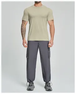 Männliches Model trägt olivgrünes Lyocell-Merino-Sportshirt mit grauer Cargo-Hose