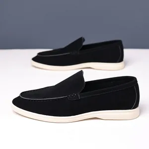 Side view of premium black suede British style loafers with white contrast rubber sole