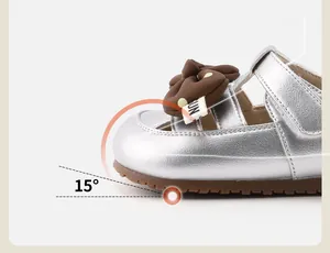 Detail of silver toddler shoes featuring an ergonomic 15-degree upturned toe design.