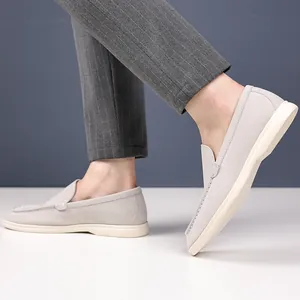 Detailed side view of grey suede men's loafers with retro British casual slip-on design