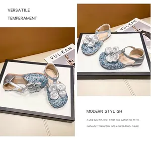 Detail view of sparkly blue girls' princess sandals with decorative flower and rhinestones.
