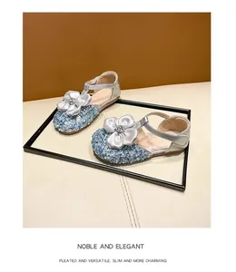 Detailed view of silver girls princess sandals with blue glitter and large satin flower