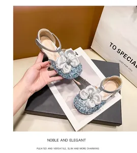 Detailed view of sparkly blue girls' princess shoes featuring silver rhinestone bows