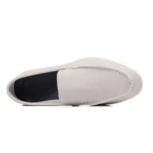 Top-down view of grey leather casual slip-on loafers with delicate white stitching detail.