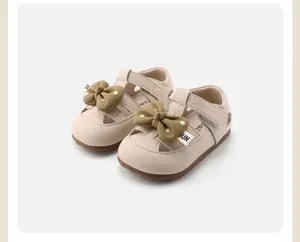 Comfortable beige toddler girls walking shoes with large olive green polka dot bow