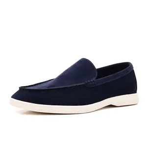Detailed side profile view of premium navy blue suede loafers with durable white rubber soles