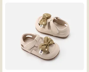 Beige toddler girl shoes with a khaki polka dot bow and comfortable T-strap velcro.