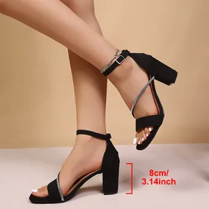 Close-up of black chunky heel sandals with rhinestone straps and 8cm heel height detail.
