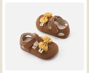 Detailed view of brown toddler walking shoes with yellow polka-dot bow and soft sole