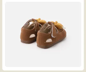Detailed rear view of brown toddler girl walker shoes featuring a cute yellow bow accent