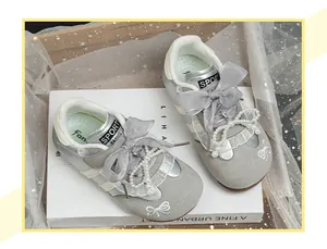 Detail of silver girls casual shoes with ribbon bows and pearl butterfly charms
