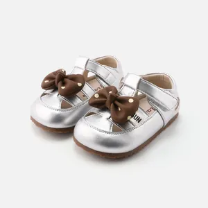 Girls' silver metallic toddler shoes with decorative brown bows and soft soles