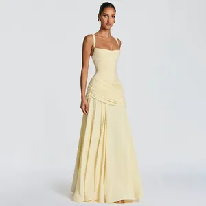 Detail of elegant pale yellow square neck dress with ruched bodice and flowing skirt