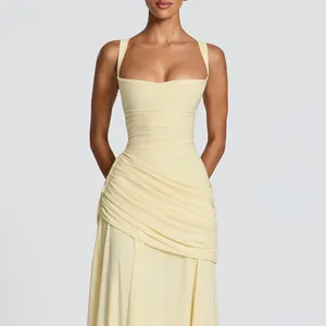Detail of a light yellow square neck dress with elegant ruched and draped textures