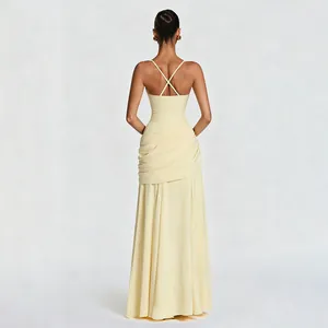 Back view of a light yellow floor-length dress with criss-cross straps and ruched waist
