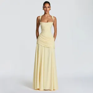 Full body view of elegant ruched pale yellow dress with square neck and pleated waist