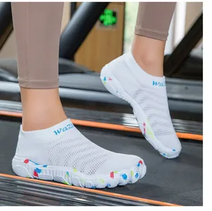 White breathable training sock shoes with speckled soles worn on a treadmill