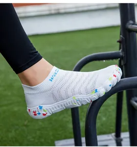 Detailed view of breathable white knit water shoes with colorful speckled sole