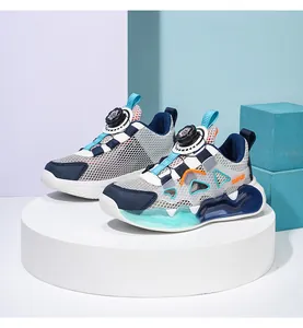 Detailed view of children's mesh sports sneakers with a modern rotary buckle closure system.