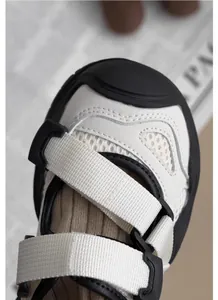 Detailed macro view showing the material and straps of children's white mesh sandals