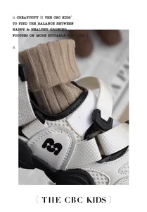 Close-up of white and black children's closed-toe sandal with breathable mesh and straps.