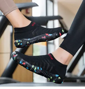 Close-up side view detail of breathable knit water shoes with colorful patterned soles