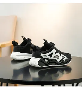 Detailed close-up view of breathable mesh children's sports sneakers in black and white