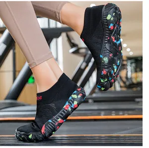 Close-up of breathable black fitness socks shoes with colorful non-slip soles on treadmill