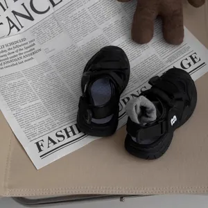 Detailed top view of breathable black children's hollow closed-toe summer sandals