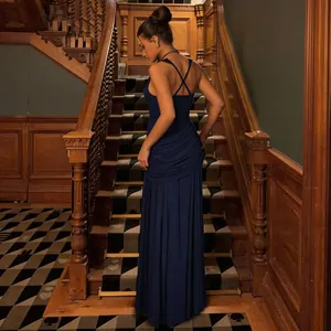 Elegant navy blue floor-length gown with cross-back straps and ruched detailing