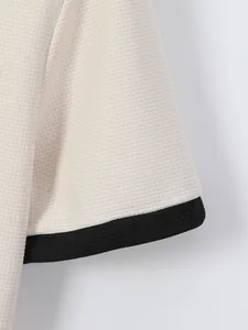 Detailopname van de mouw van een herenpolo met wafeltextuur en een zwarte contrasterende manchet