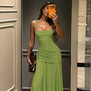 Close-up of elegant lime green slim-fit ruched maxi dress with square neckline