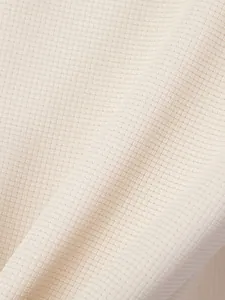 Macrodetail van de crème wafelgebreide stoftextuur voor casual poloshirts voor heren