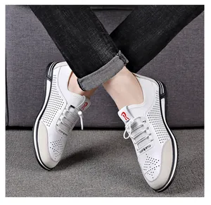 Detail of white breathable men's casual shoes with hollowed pattern and soft sole.