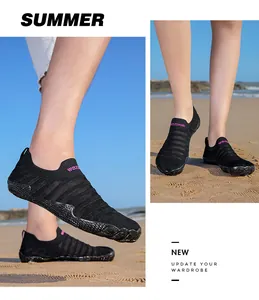 Action shots of black mesh water shoes with non-slip soles on a sandy beach background.