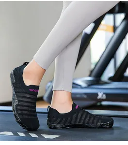 Close-up of breathable black water shoes being used for training on a gym treadmill