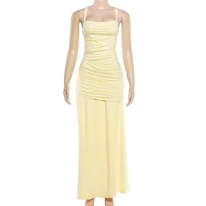 Detail view of a yellow floor-length ruched dress with square neck on a mannequin.