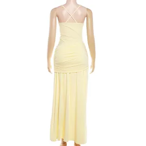 Back view of a pale yellow slim-fit maxi dress with ruched details and criss-cross straps.