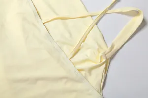 Close-up of high-quality stitching on a light yellow square neck slim fit dress.