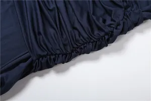 Detailed macro view showing the elegant navy blue ruched fabric texture of the dress.