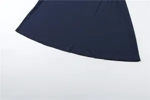 Close-up detail shot of dark navy blue dress hemline showing smooth fabric and stitching