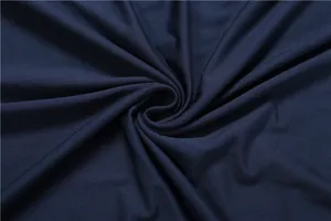 Macro detail of soft navy blue pleated fabric with elegant spiral drapery for women dress