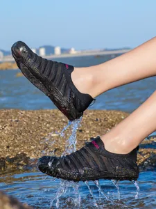 Breathable black aqua shoes for swimming and beach sports with water splash