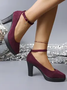 Elegant burgundy suede platform high heels with block heel and ankle strap on feet