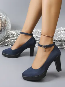 Side view of navy blue suede chunky high heels with ankle strap and round toe