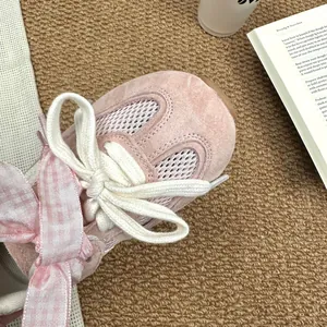 Detailed close-up view of pink breathable mesh GAT sneakers for girls with satin bow