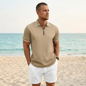 Men's khaki zip-up polo shirt with jacquard texture shown in a casual beach setting.